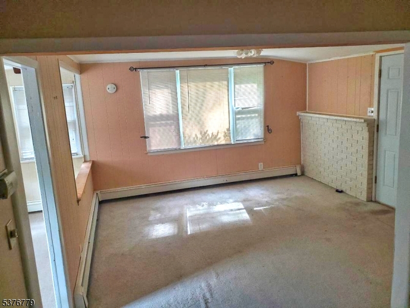 4 Village Place Oak Ridge, NJ 07438 - Photo 3 of 15 an empty room with windows and entrance