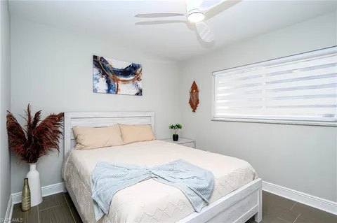 a bedroom with a large bed and a window