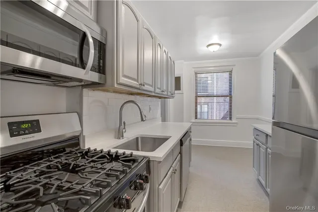 a kitchen with stainless steel appliances granite countertop a stove and a refrigerator