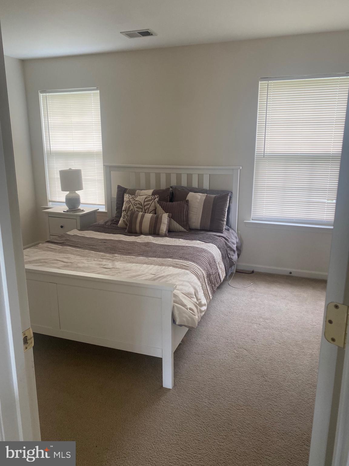 94 Rydal Circle Magnolia, DE 19962 - Photo 16 of 23 a bed sitting in a bedroom next to a window