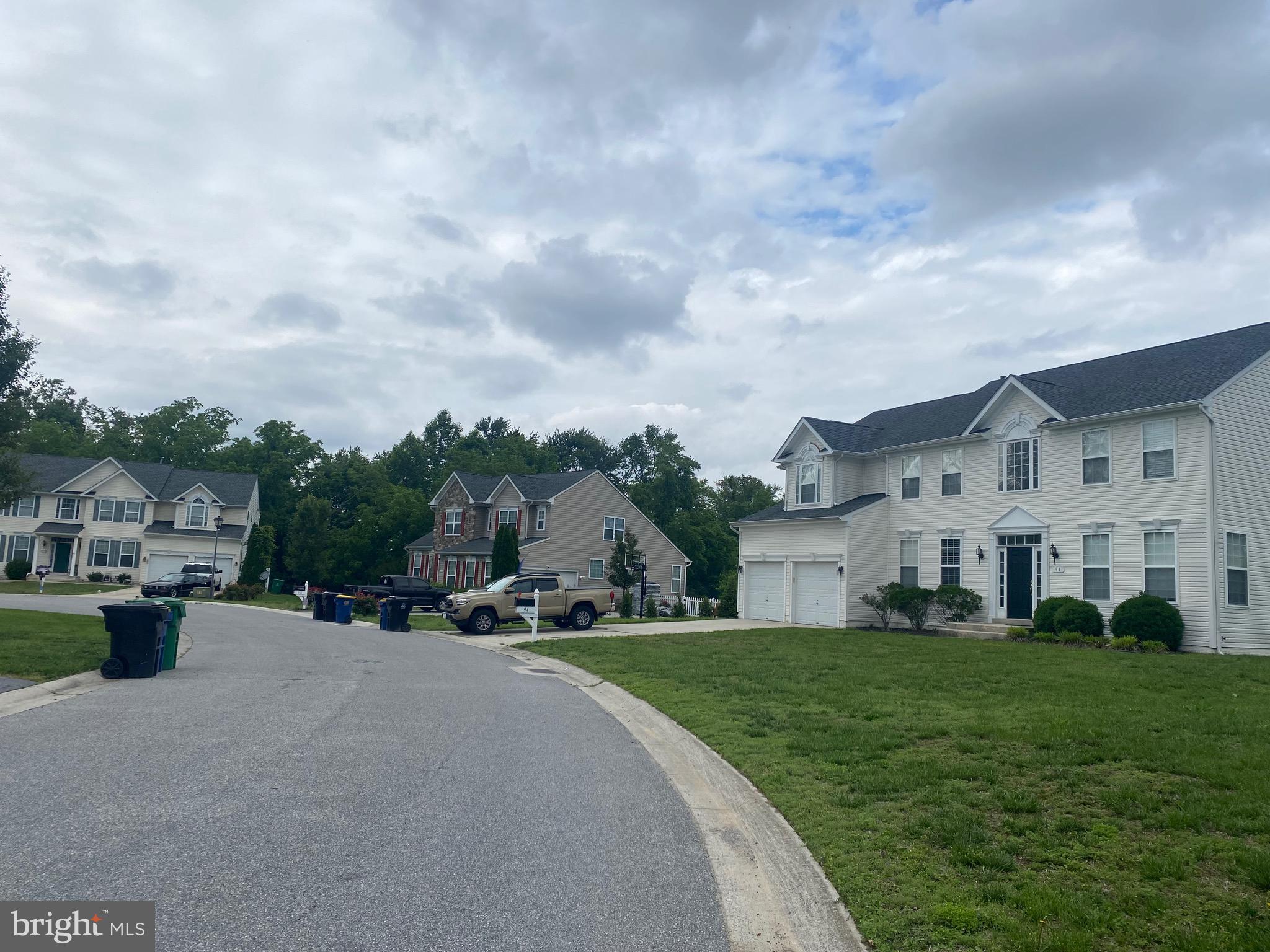 94 Rydal Circle Magnolia, DE 19962 - Photo 4 of 23 a view of a white house in front of a big yard with potted plants