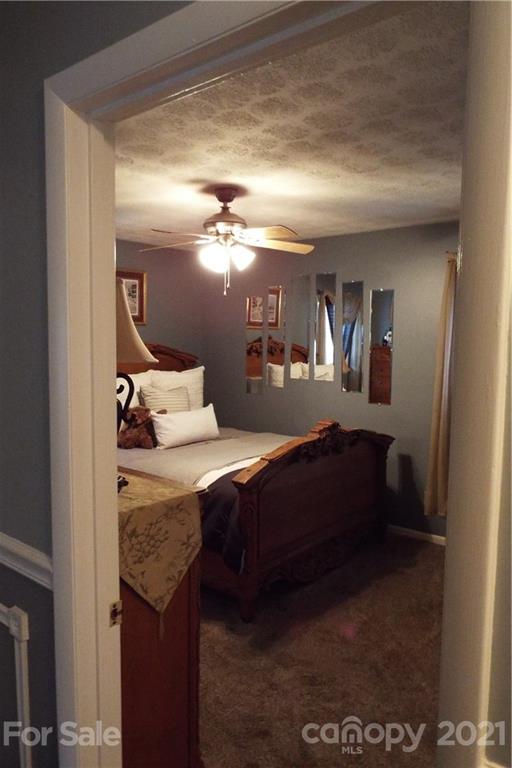 7905 Barkley Road Sherrills Ford, NC 28673 - Photo 20 of 31 a bedroom with a bed and lamp