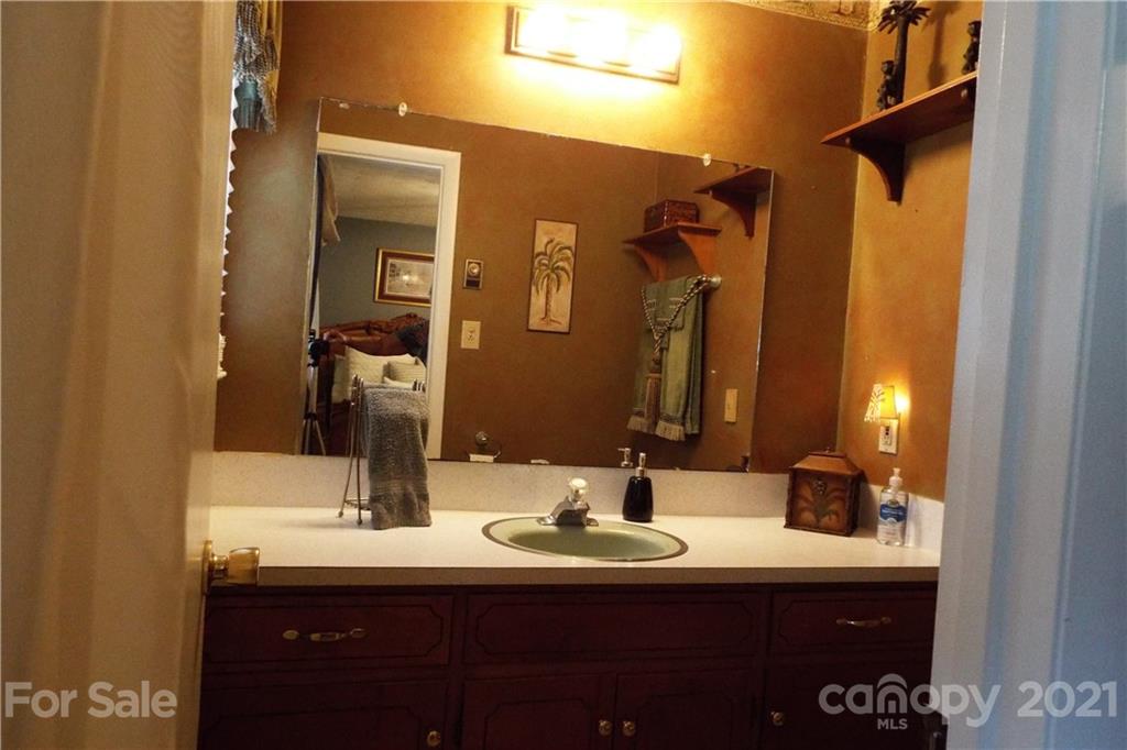 7905 Barkley Road Sherrills Ford, NC 28673 - Photo 22 of 31 a bathroom with a double vanity sink and a mirror
