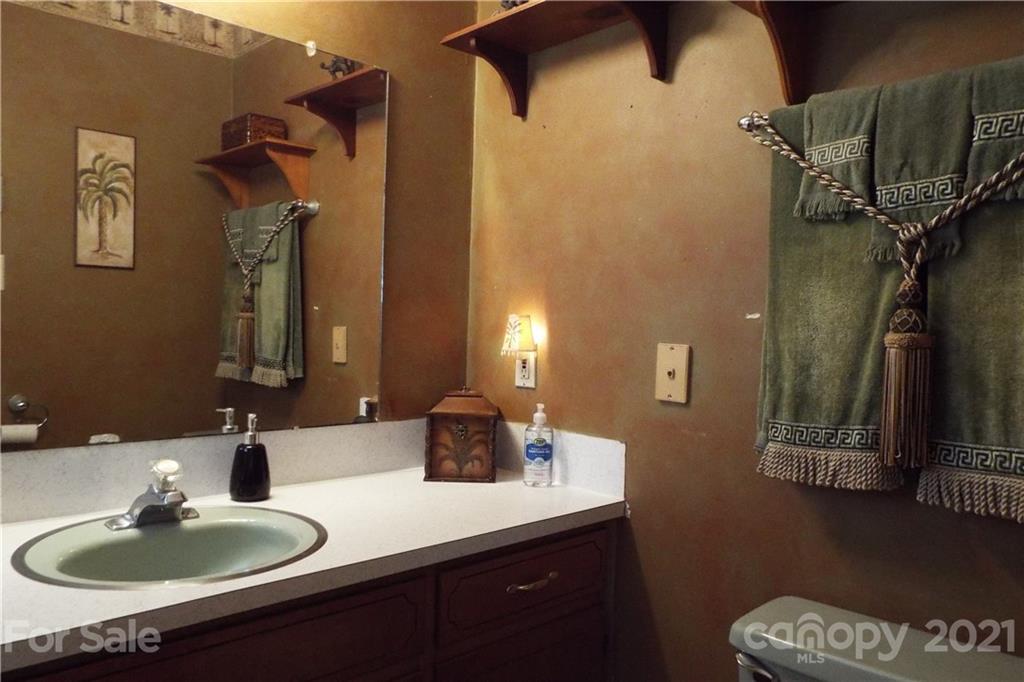 7905 Barkley Road Sherrills Ford, NC 28673 - Photo 23 of 31 a bathroom with a sink a mirror and vanity