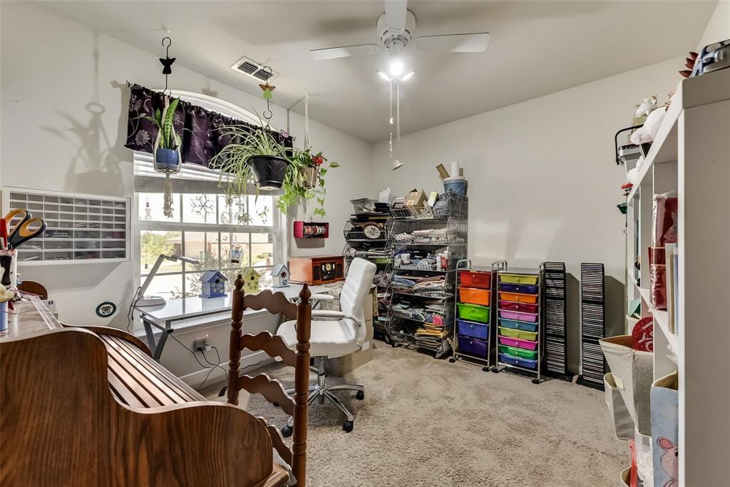 1300 Clegg Street Howe, TX 75459 - Photo 11 of 14 Carpeted room featuring a ceiling fan with integrated lighting, a window with decorative muntins, and a sloped ceiling