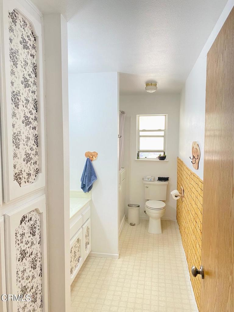 18300 Grant Place Tehachapi, CA 93561 - Photo 12 of 28 a bathroom with a toilet sink and shower curtain