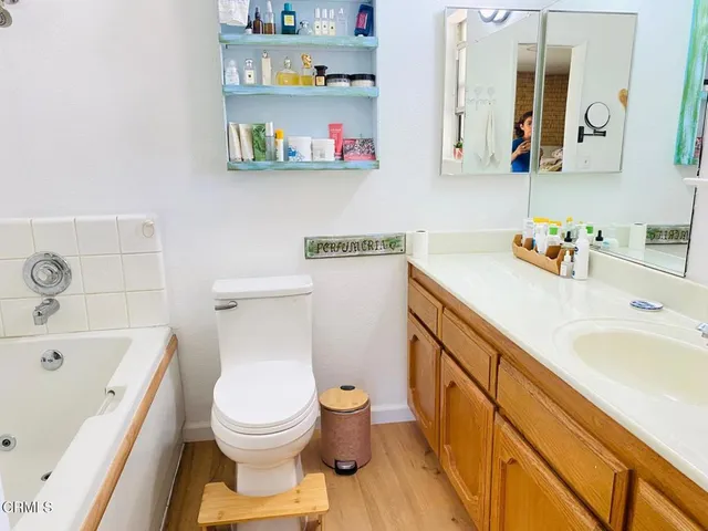 a bathroom with a sink a vanity and toilet