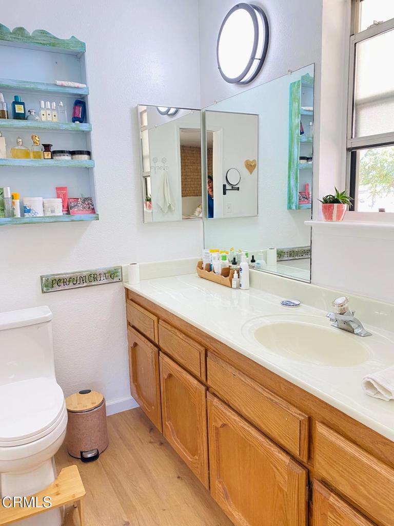 18300 Grant Place Tehachapi, CA 93561 - Photo 15 of 28 a bathroom with a granite countertop toilet sink and a mirror