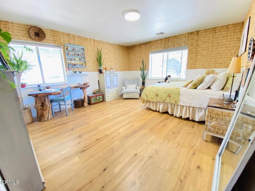 18300 Grant Place Tehachapi, CA 93561 - Photo 5 of 28 a spacious bedroom with a bed a table and chair