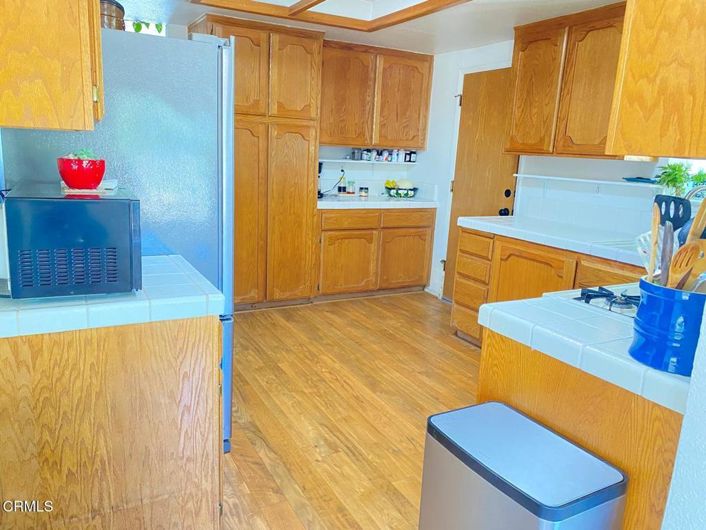 18300 Grant Place Tehachapi, CA 93561 - Photo 9 of 28 a kitchen with stainless steel appliances kitchen island sink stove and cabinets