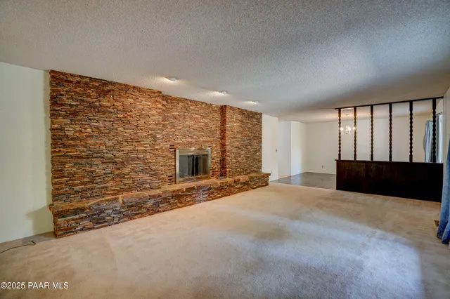 a view of an empty room with a fireplace