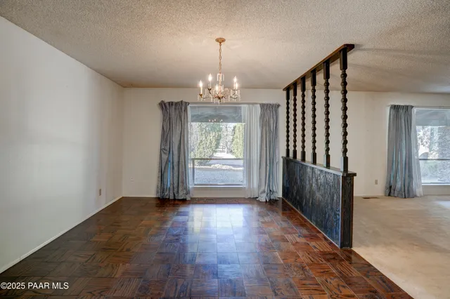 a kitchen with stainless steel appliances wooden floor and a refrigerator