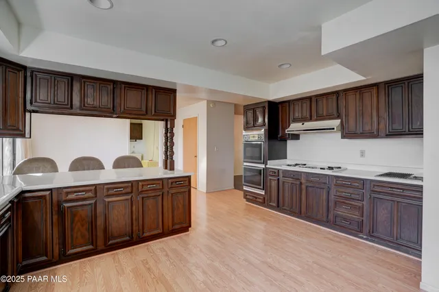 an empty room with large windows and a fireplace