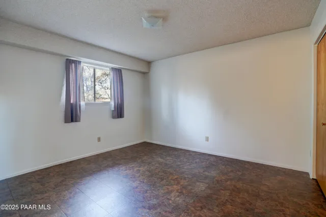a view of a room with wooden floor and windows