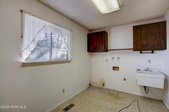 a balcony with wooden floor and trees in the back