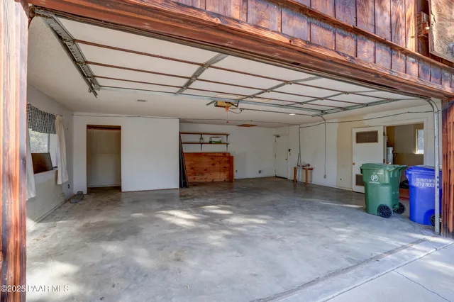 a view of a house with a yard and wooden fence