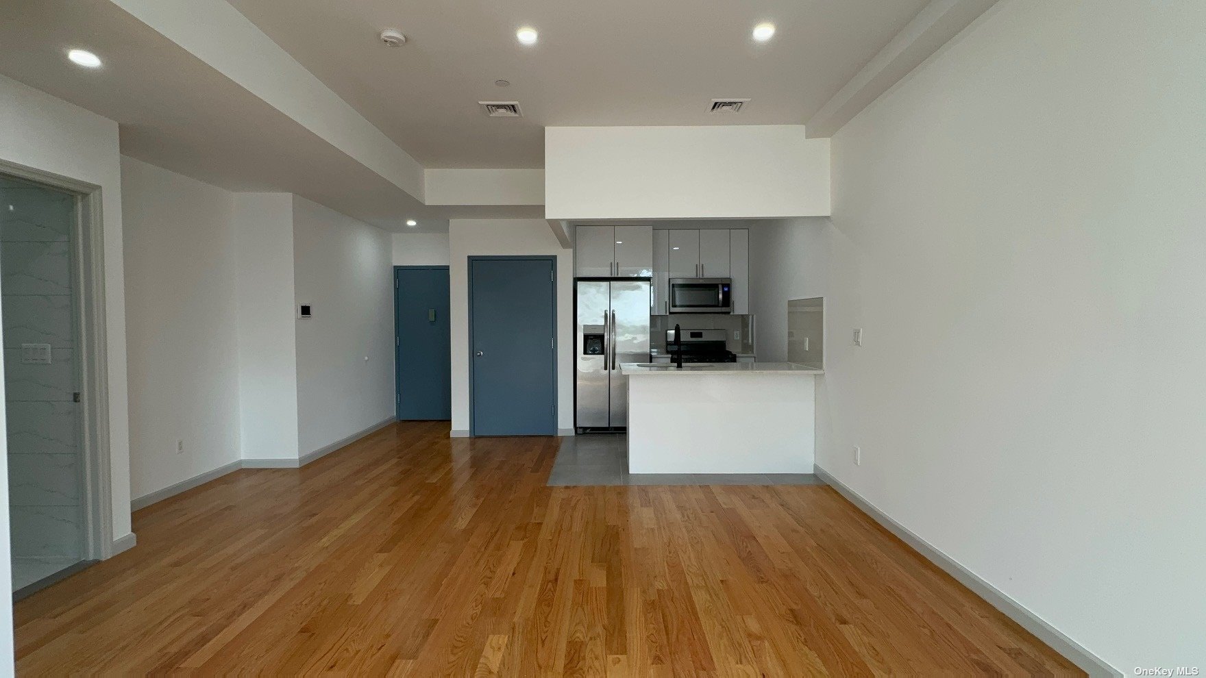 1821 Grove Street Queens, NY 11385 - Photo 16 of 30 a view of kitchen with cabinets appliances and wooden floor