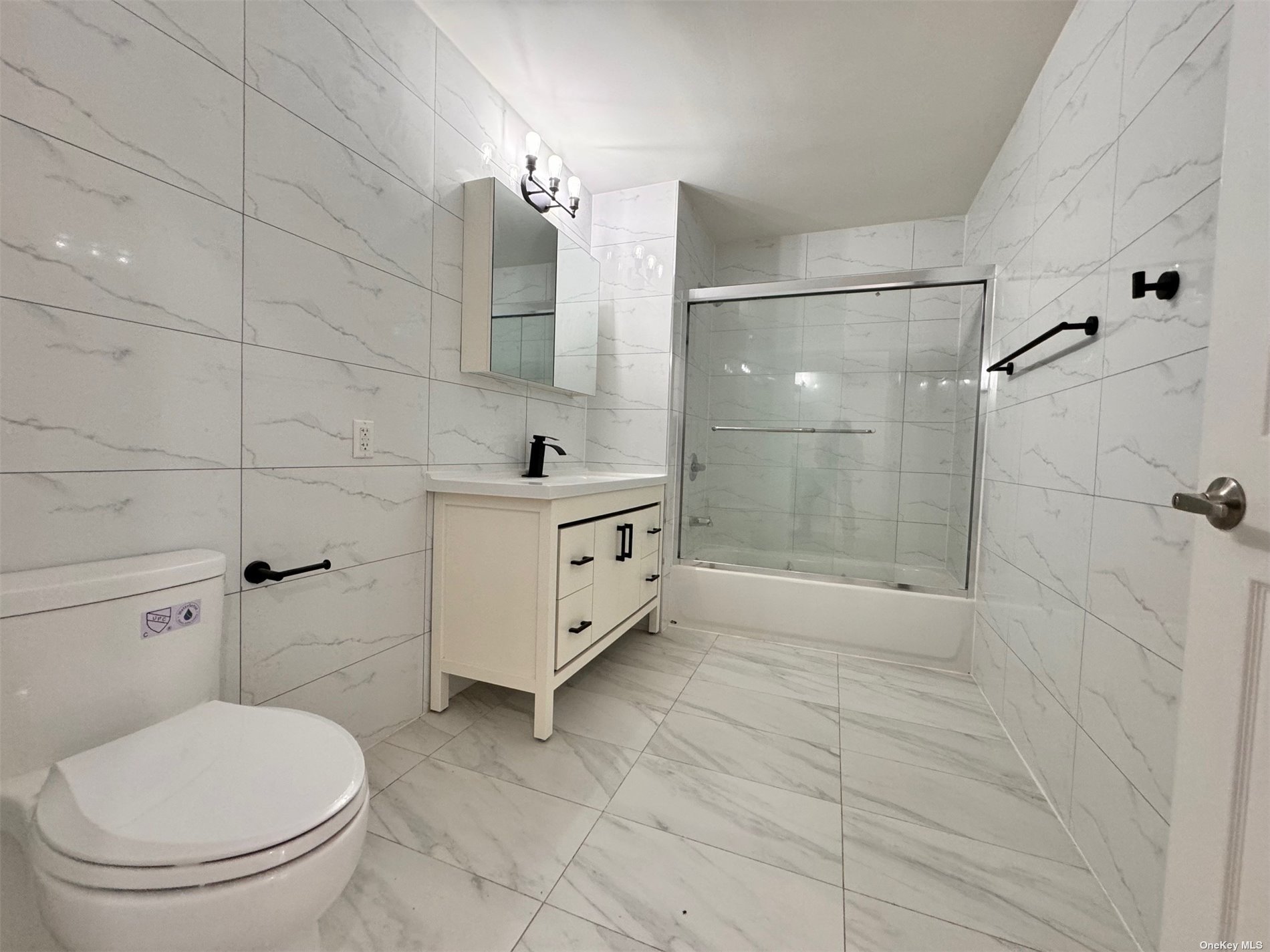 1821 Grove Street Queens, NY 11385 - Photo 26 of 30 a bathroom with a toilet a sink and shower