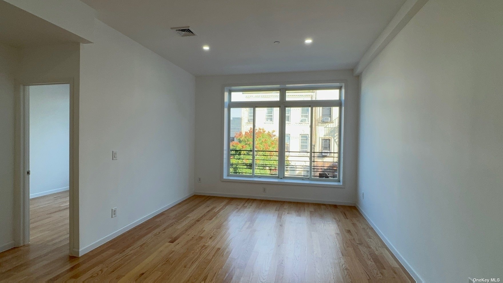 1821 Grove Street Queens, NY 11385 - Photo 29 of 30 a view of an empty room with wooden floor and a window