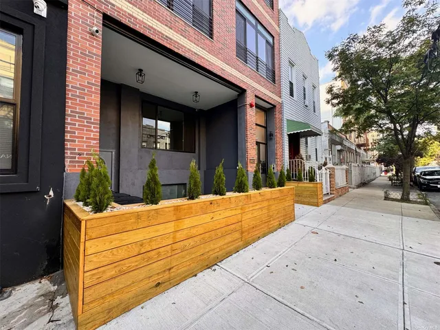 a view of a building with potted plants