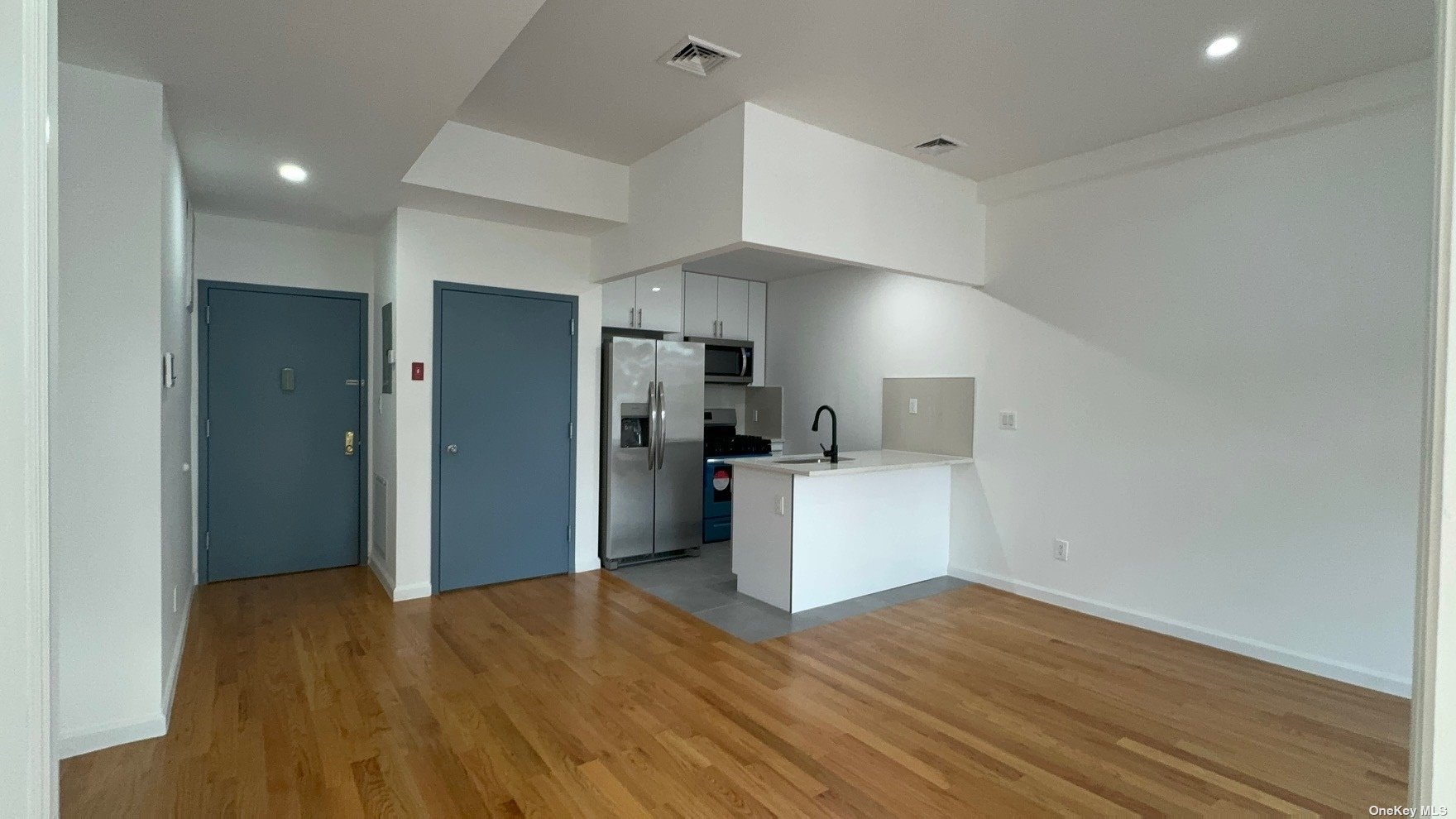 1821 Grove Street Queens, NY 11385 - Photo 9 of 30 a view of a kitchen with a sink and a refrigerator