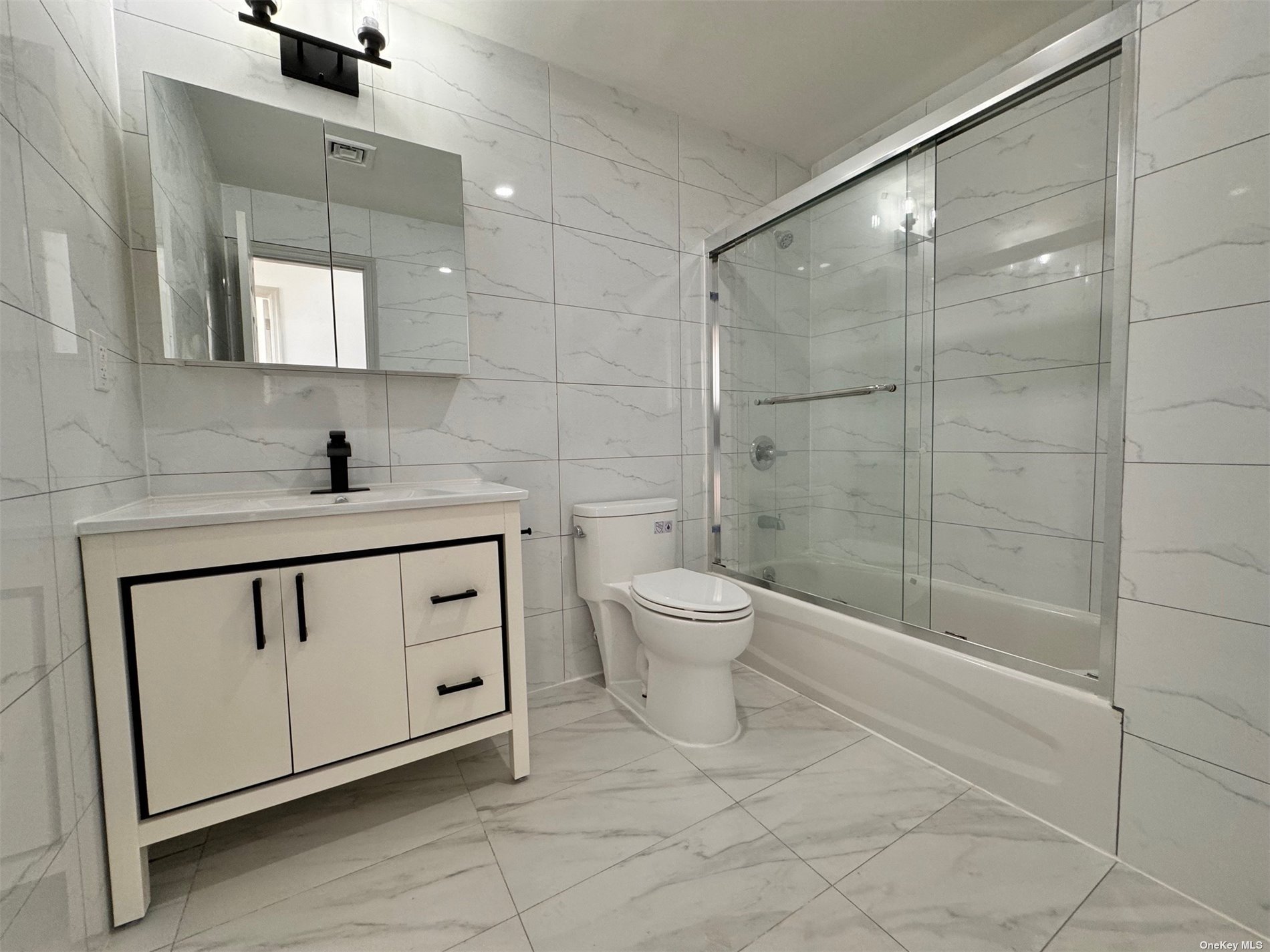 1821 Grove Street Queens, NY 11385 - Photo 10 of 30 a bathroom with a toilet sink and a shower