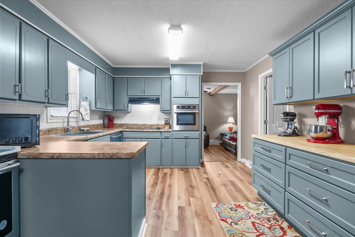 140 Mockingbird Street Erin, TN 37061 - Photo 1 of 36 a kitchen with granite countertop a sink stove and cabinets