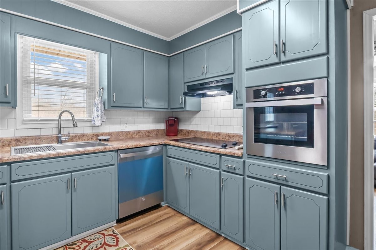 140 Mockingbird Street Erin, TN 37061 - Photo 12 of 36 a kitchen with sink cabinets and window