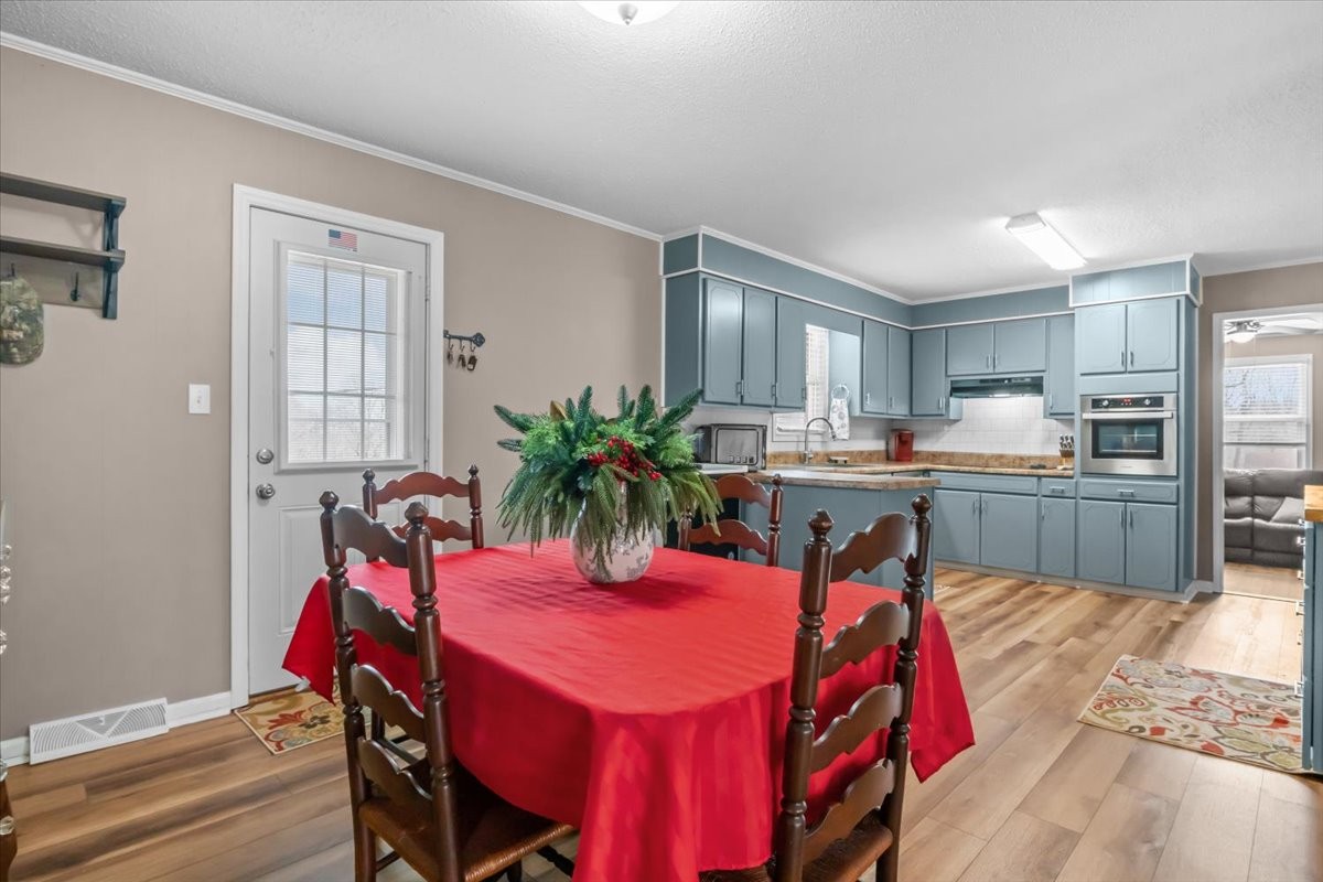 140 Mockingbird Street Erin, TN 37061 - Photo 14 of 36 a view of a dining room with furniture and a kitchen
