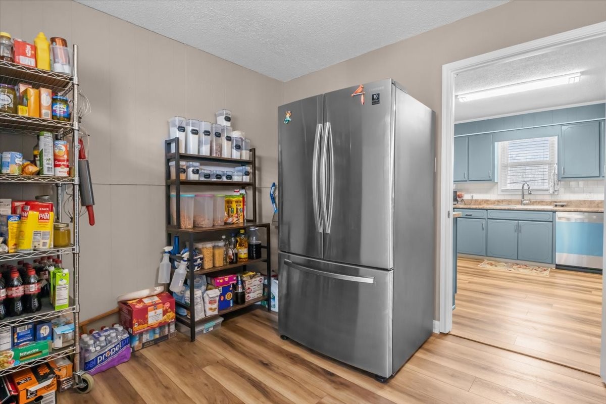140 Mockingbird Street Erin, TN 37061 - Photo 15 of 36 a kitchen with refrigerator and wooden floor