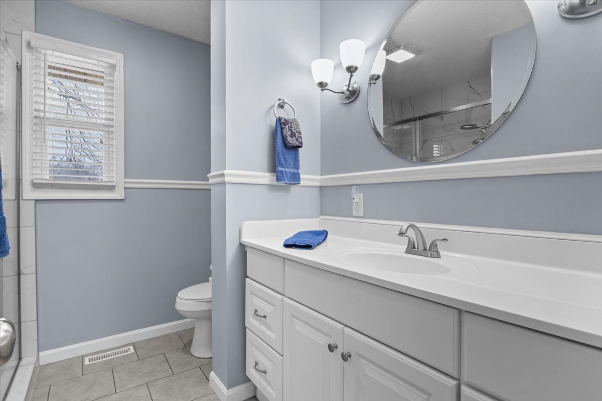 140 Mockingbird Street Erin, TN 37061 - Photo 19 of 36 a bathroom with a sink a toilet and a mirror