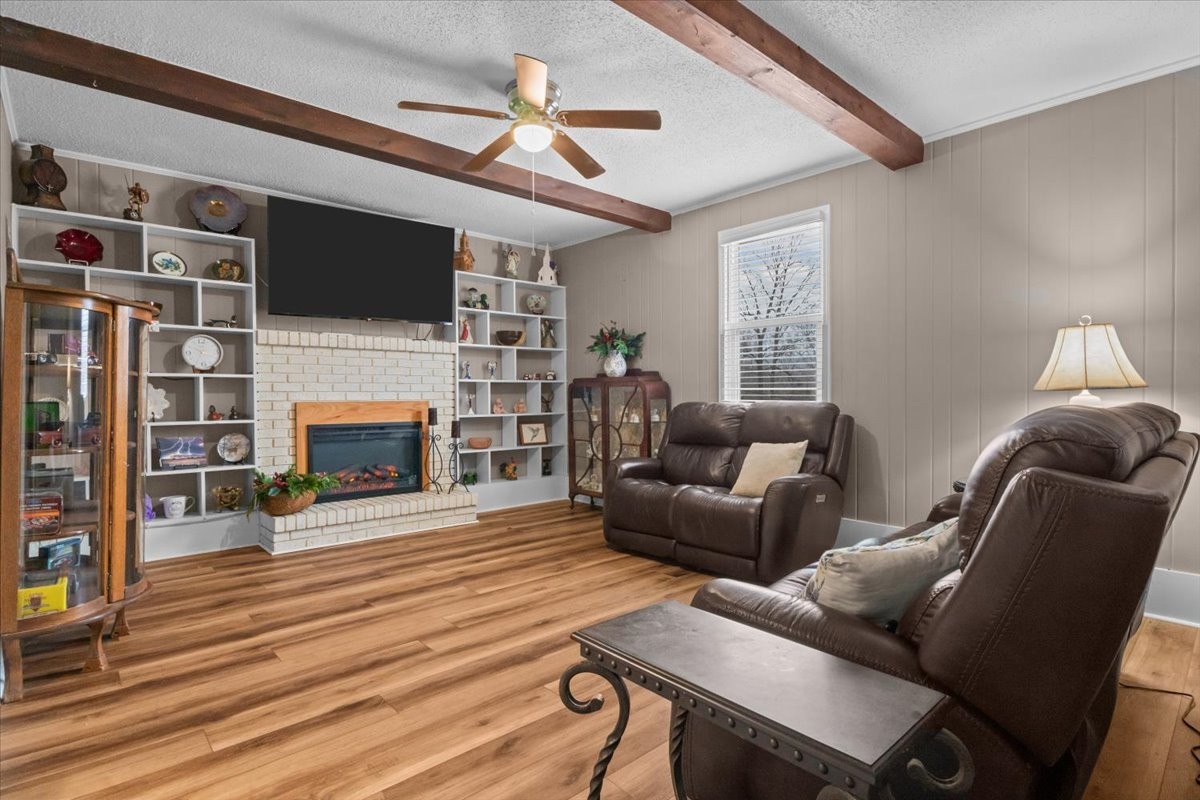 140 Mockingbird Street Erin, TN 37061 - Photo 21 of 36 a living room with furniture a flat screen tv and a fireplace