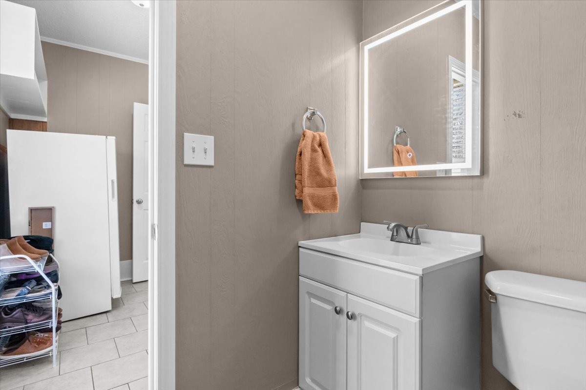 140 Mockingbird Street Erin, TN 37061 - Photo 24 of 36 a bathroom with a sink a toilet and a mirror