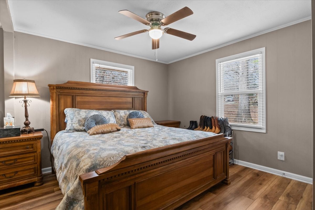 140 Mockingbird Street Erin, TN 37061 - Photo 26 of 36 a bedroom with a bed and a chandelier