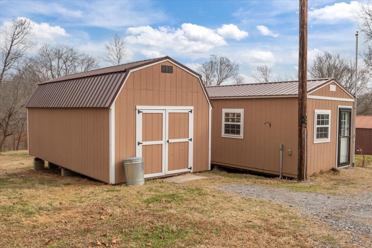 140 Mockingbird Street Erin, TN 37061 - Photo 33 of 36 a view of a house with a backyard