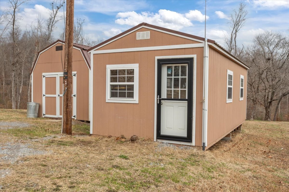 140 Mockingbird Street Erin, TN 37061 - Photo 34 of 36 a view of a house with a yard
