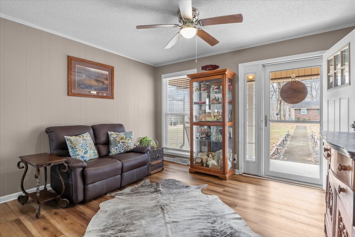 140 Mockingbird Street Erin, TN 37061 - Photo 9 of 36 a living room with furniture and a floor to ceiling window
