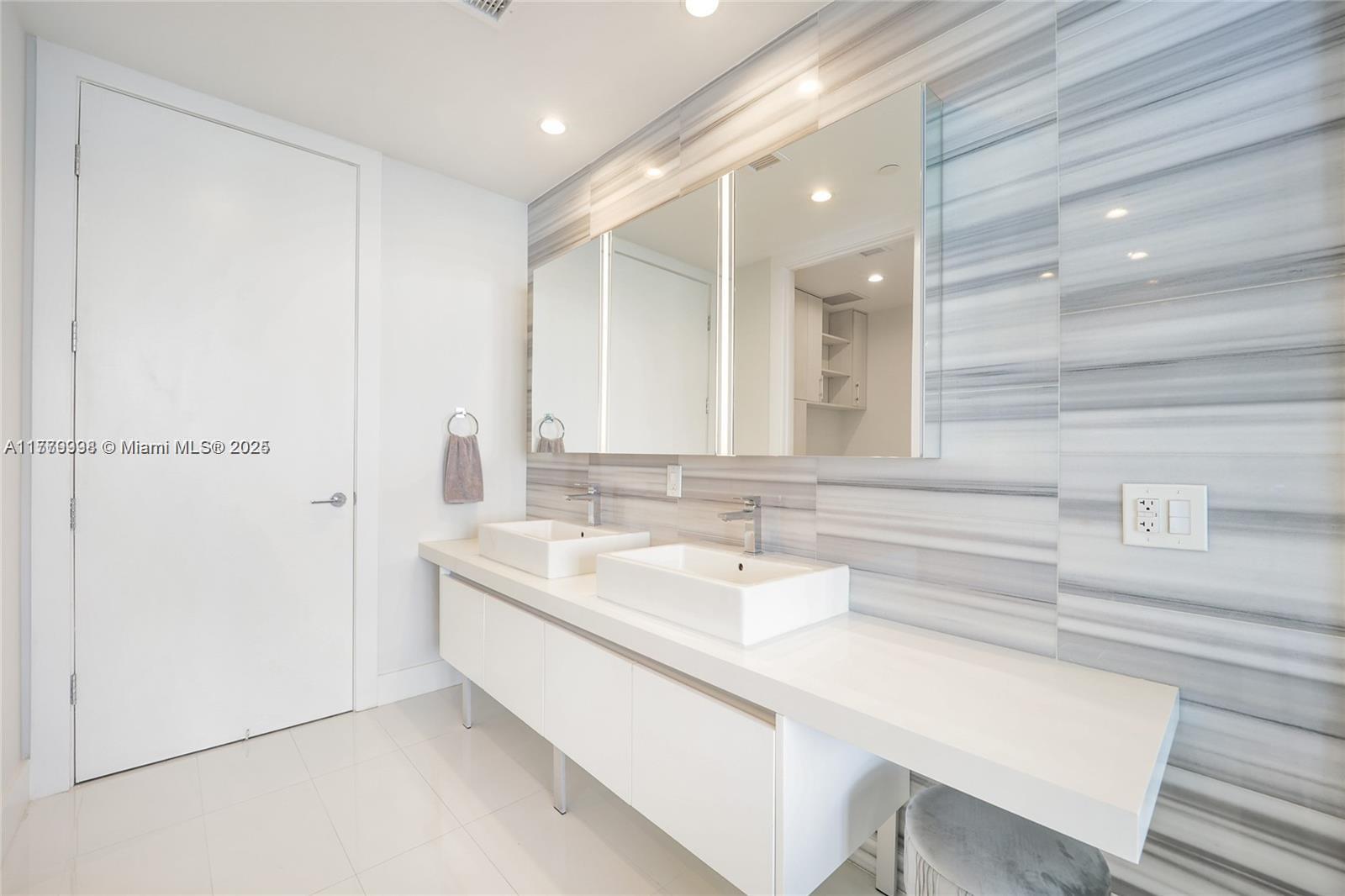 1100 Biscayne Boulevard, Unit 3004 Miami, FL 33132 - Photo 13 of 15 a bathroom with a sink and a mirror