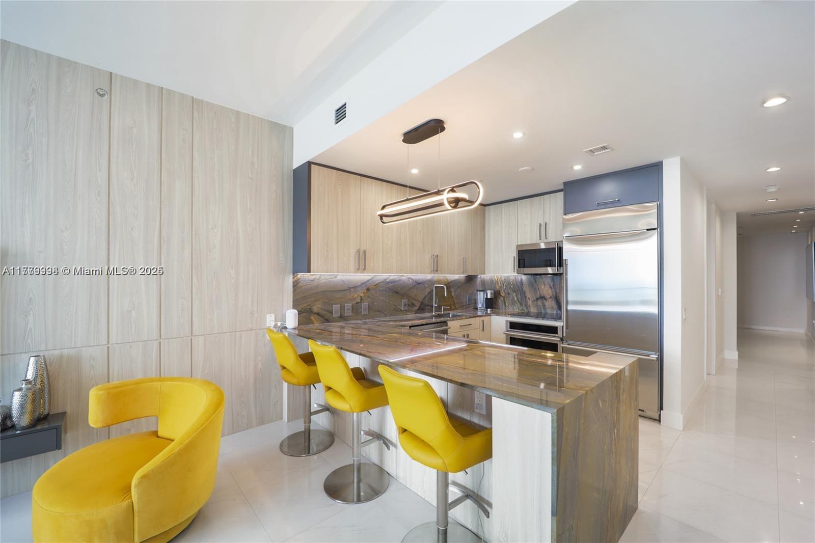 1100 Biscayne Boulevard, Unit 3004 Miami, FL 33132 - Photo 3 of 15 a kitchen with a sink cabinets and appliances