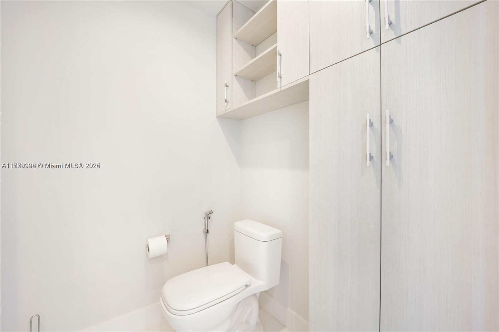 1100 Biscayne Boulevard, Unit 3004 Miami, FL 33132 - Photo 9 of 15 a white toilet sitting next to a shower