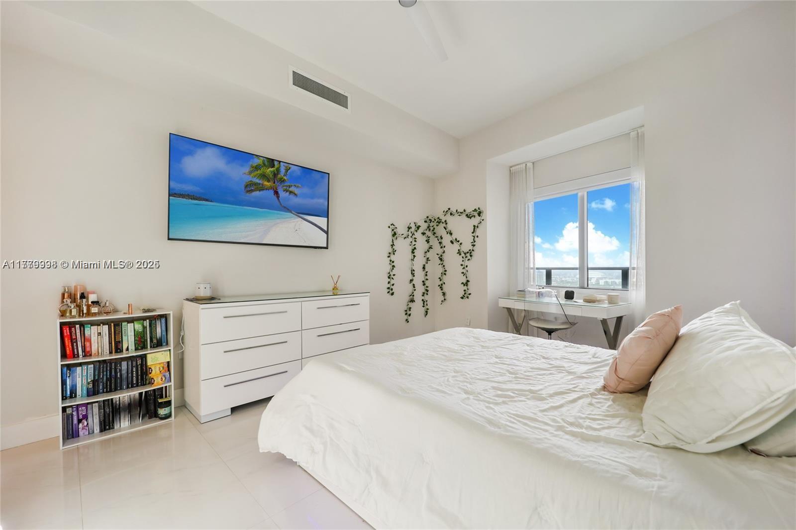 1100 Biscayne Boulevard, Unit 3004 Miami, FL 33132 - Photo 10 of 15 a bedroom with a bed and a window