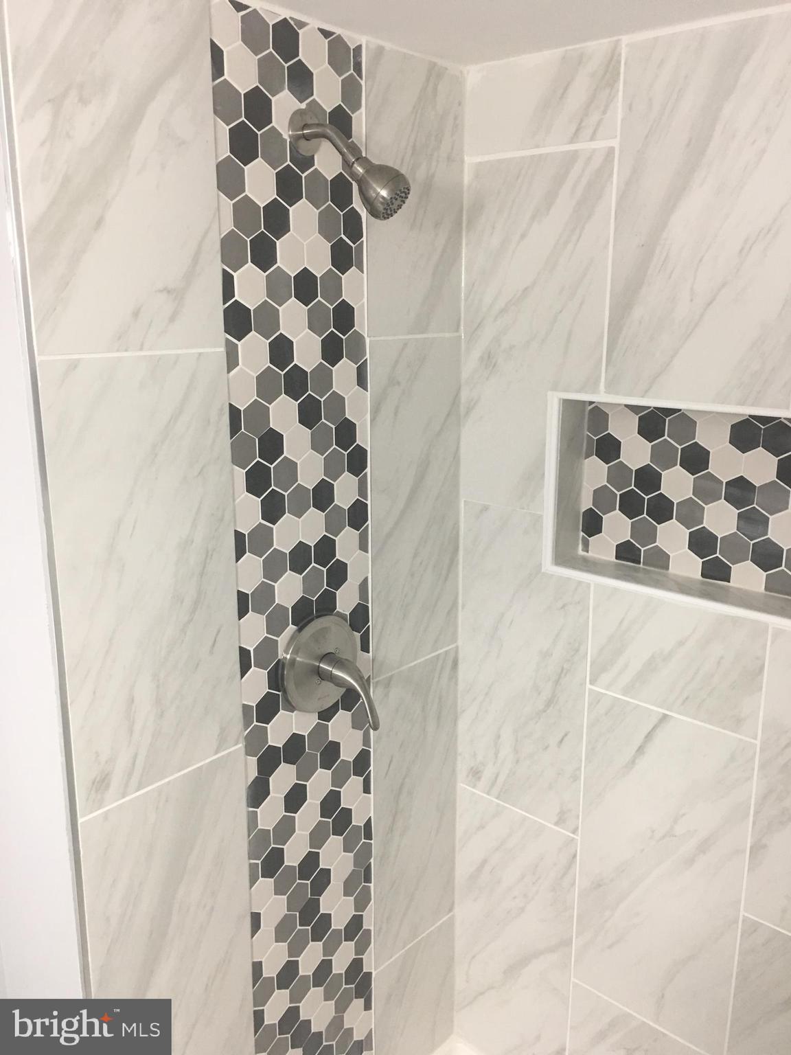 7441 Edsworth Road Baltimore, MD 21222 - Photo 32 of 37 a bathroom with a bathtub and shower