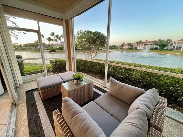 a living room with furniture and a floor to ceiling window