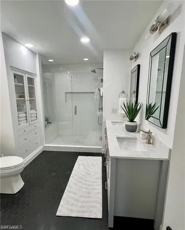 a view of bathroom with a sink and mirror