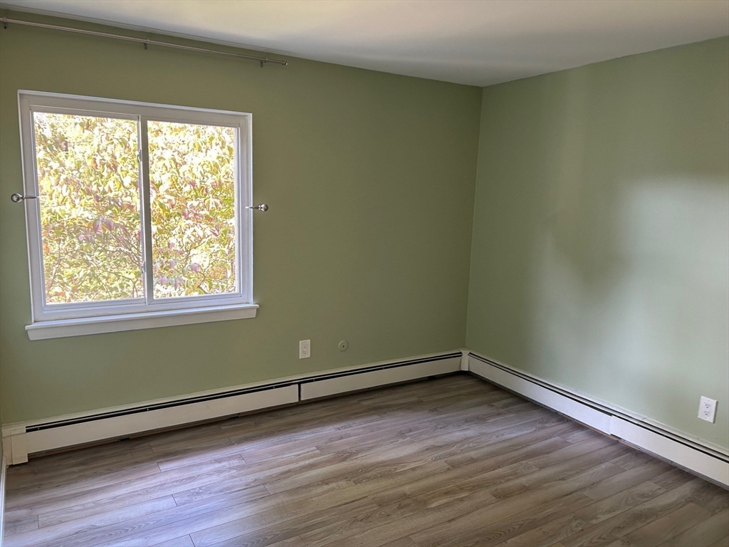 37 Will Drive, Unit 12 Canton, MA 02021 - Photo 12 of 20 a view of a room with wooden floor and a window