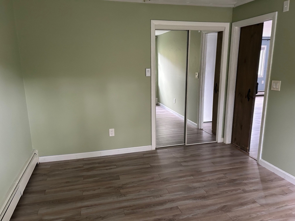 37 Will Drive, Unit 12 Canton, MA 02021 - Photo 13 of 20 a view of an empty room with wooden floor and a window