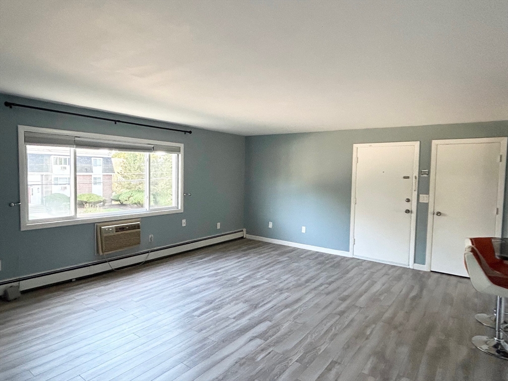 37 Will Drive, Unit 12 Canton, MA 02021 - Photo 6 of 20 an empty room with wooden floor and windows