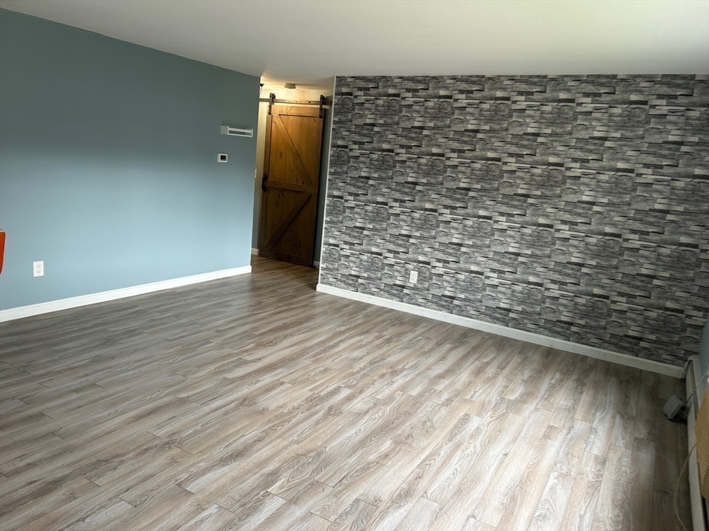 37 Will Drive, Unit 12 Canton, MA 02021 - Photo 9 of 20 a view of empty room with wooden floor