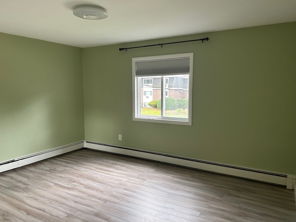37 Will Drive, Unit 12 Canton, MA 02021 - Photo 10 of 20 an empty room with wooden floor and windows