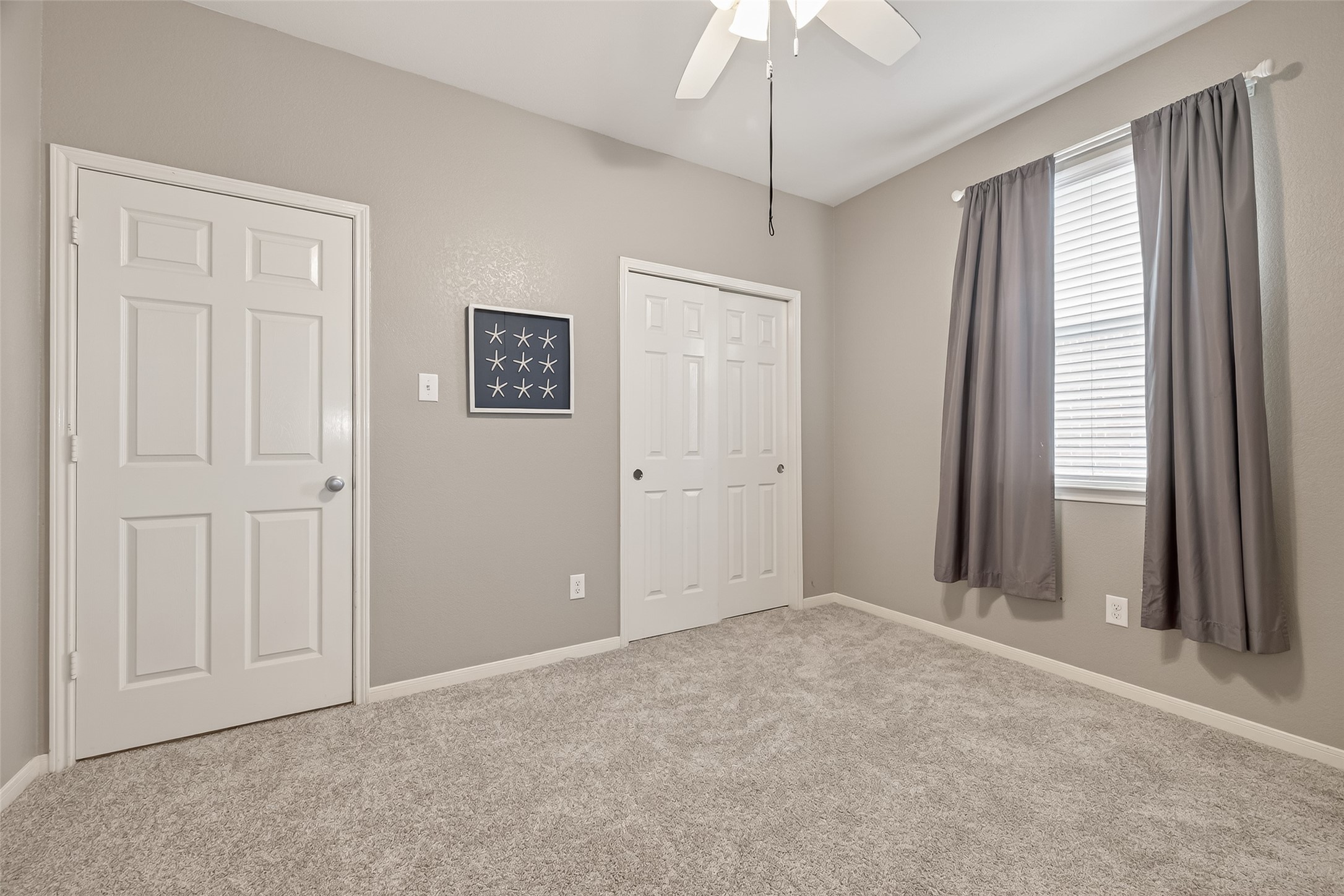 9110 Cavalier Lane Rosenberg, TX 77469 - Photo 18 of 30 Secondary bedroom includes a ceiling fan, double-door closet, and offers a bright and versatile space.